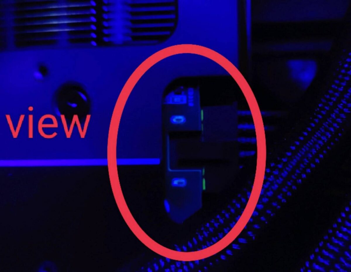 MSI yellow-coded 12V-2x6 power connector backing out from graphics card.