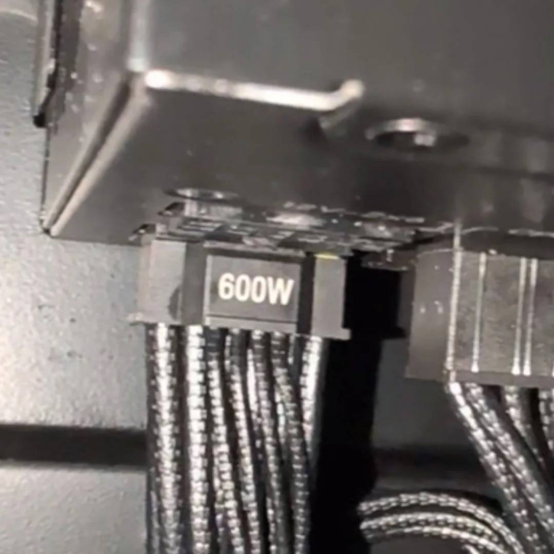 MSI yellow-coded 12V-2x6 power connector backing out from the PSU.