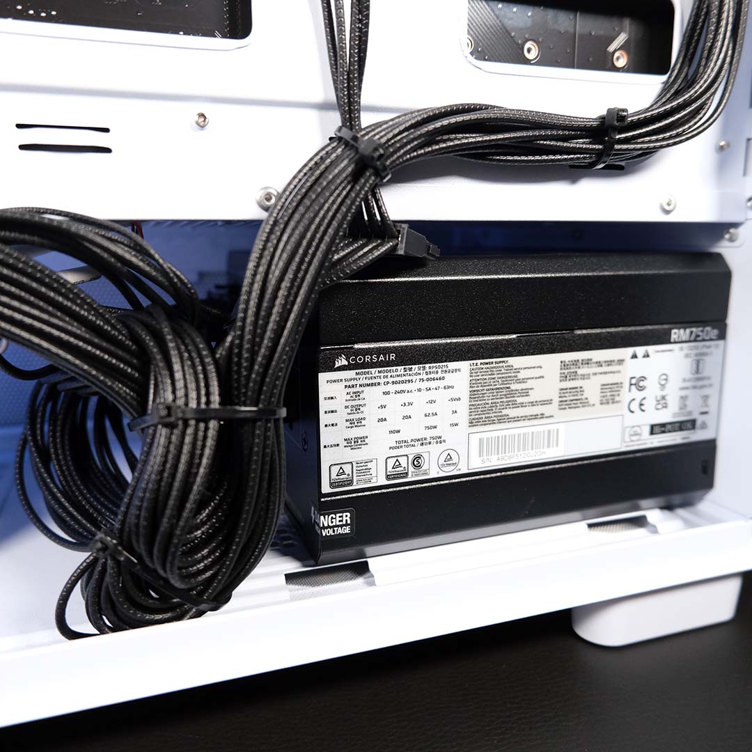 A close-up of the Corsair RM750e power supply, inside the PCSpecialist Spectrum Pro.