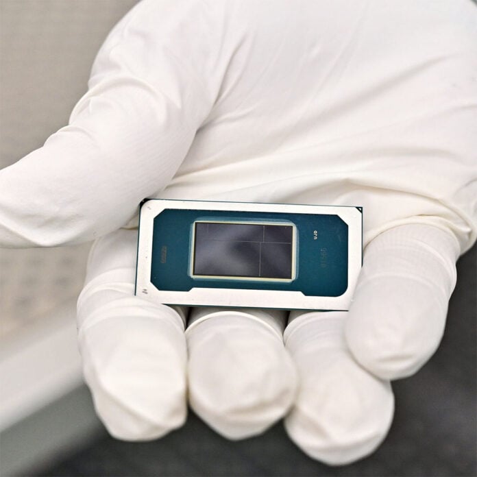 An Intel Core Ultra Series 3 processor, held in a gloved hand.