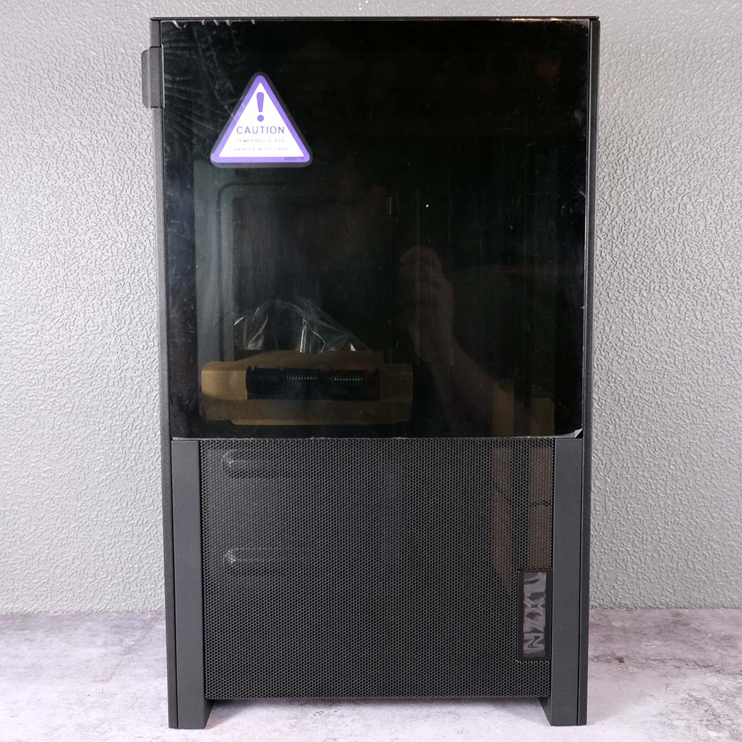A side view of the NZXT H2 Flow, panels on, accessories inside.