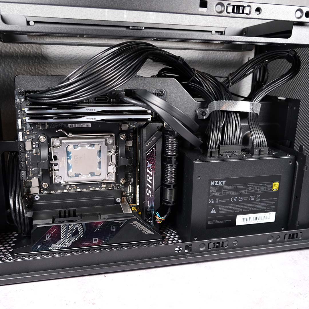 The motherboard "chamber" of the NZXT H2 Flow, now containing a motherboard, power supply, and wiring.