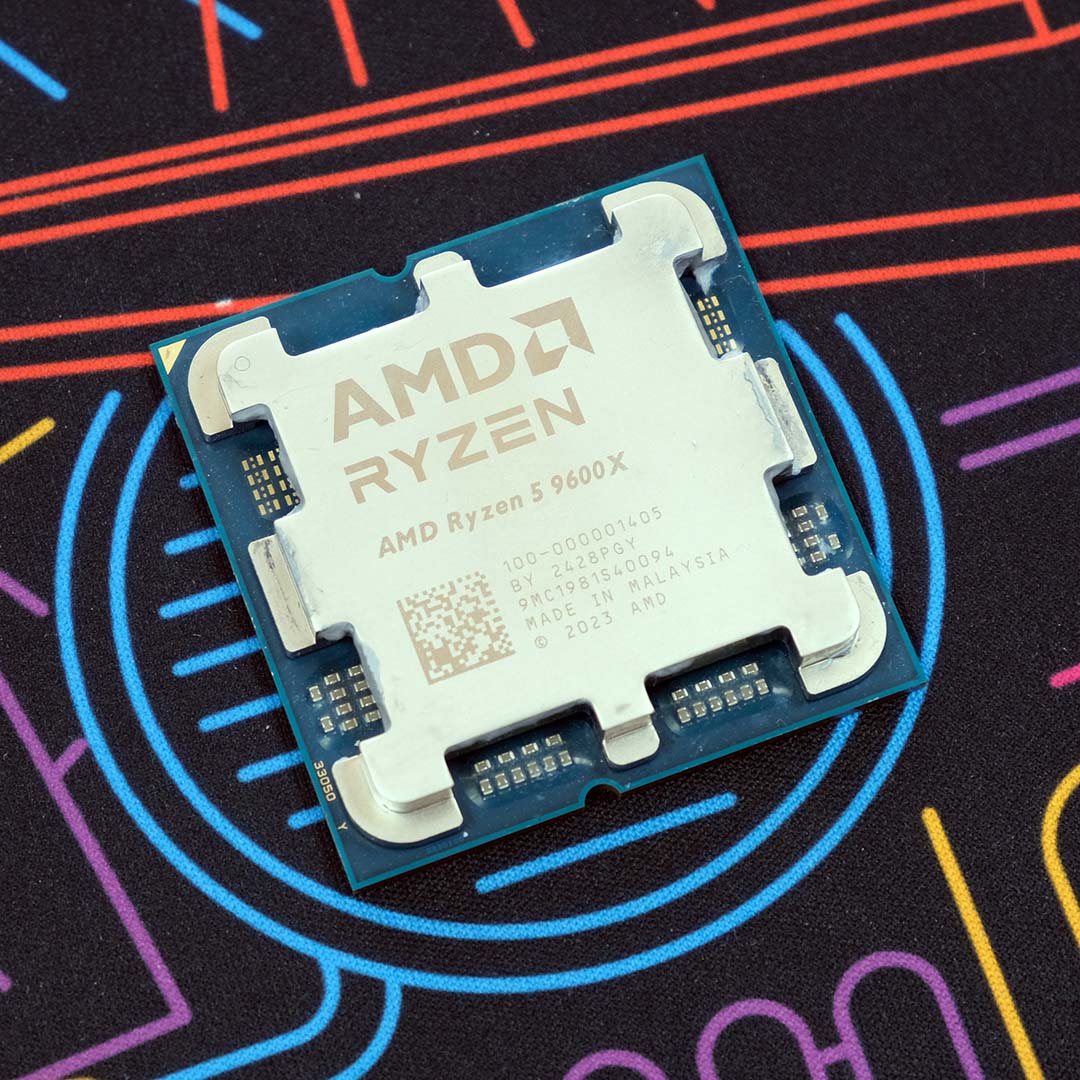 An AMD Ryzen 5 9600X processor atop a neon backdrop.