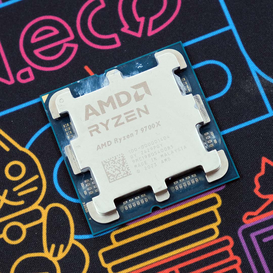 An AMD Ryzen 7 9700X processor on a neon backdrop.