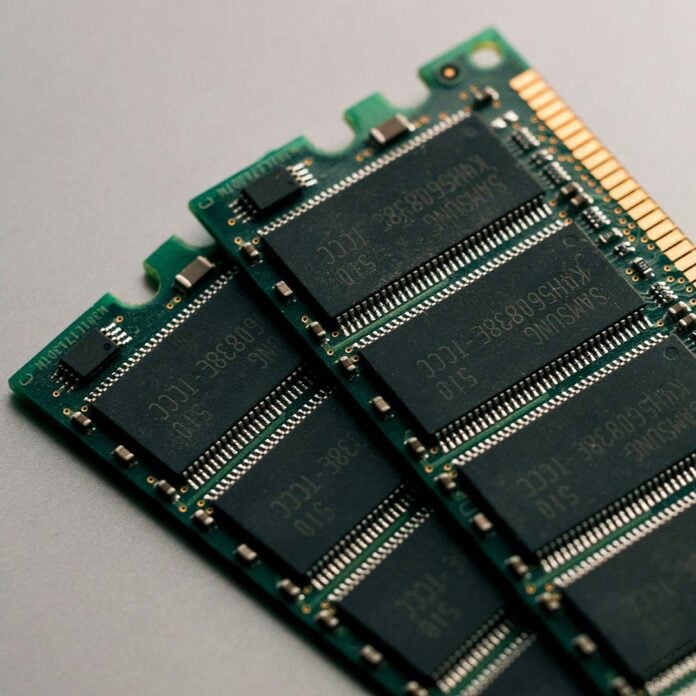 Two sticks of memory, their DRAM chips exposed.