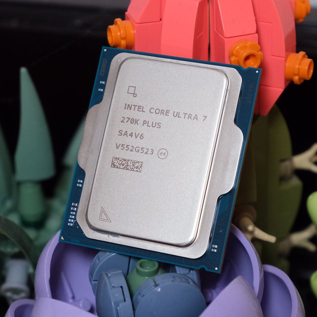 An Intel Core Ultra 7 270K Plus processor standing upright against Lego flowers.