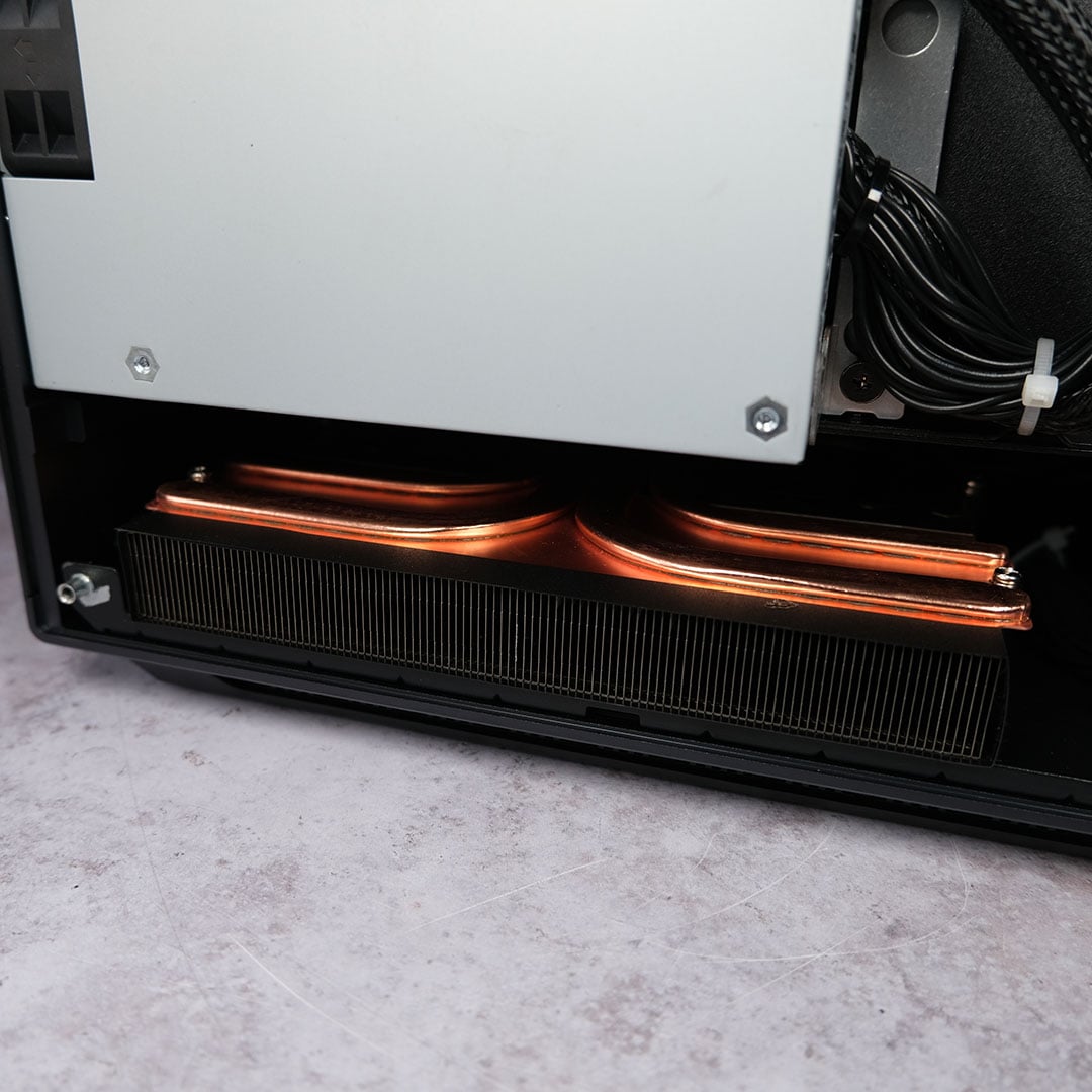 A close-up of the heatsink and copper pipes covering the Ugreen NASync iDX6011 Pro's internal components.