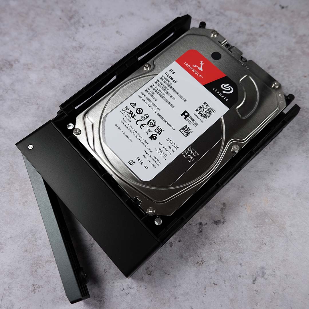 An Ironwolf Seagate HDD inside one of the Ugreen NASync iDX6011 Pro's drive bays.