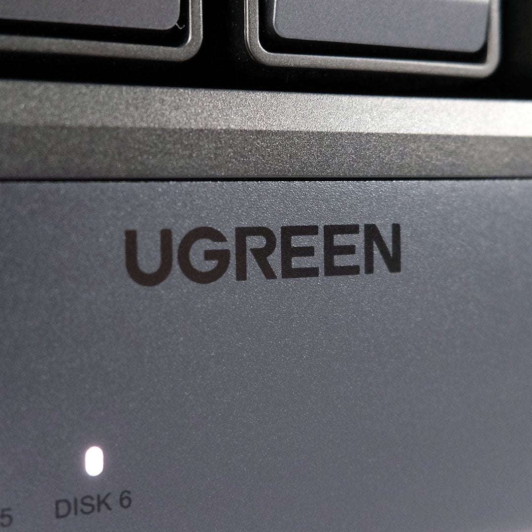 A close-up of the Ugreen logo on the NASync iDX6011 Pro.