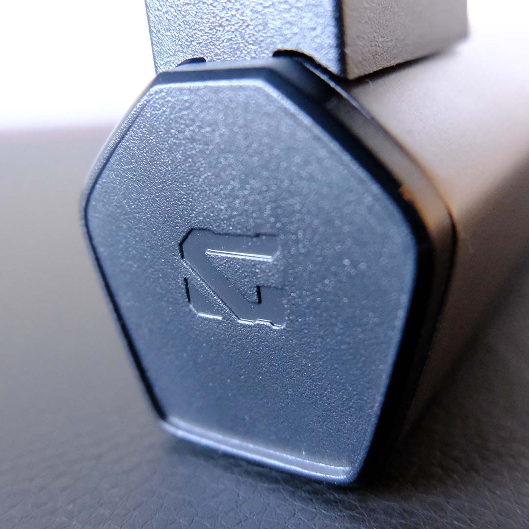 A close-up of the Gigabyte 'G' logo on the stand for the MO27Q28G monitor.