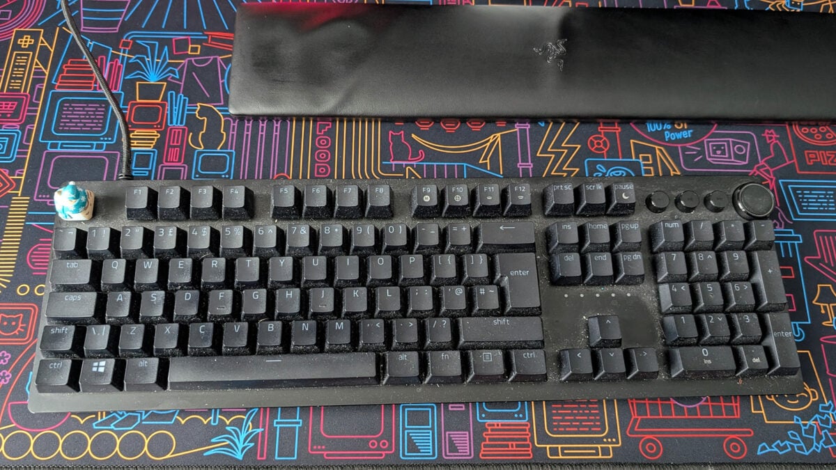A Razer Huntsman V2 keyboard, caked in grime.