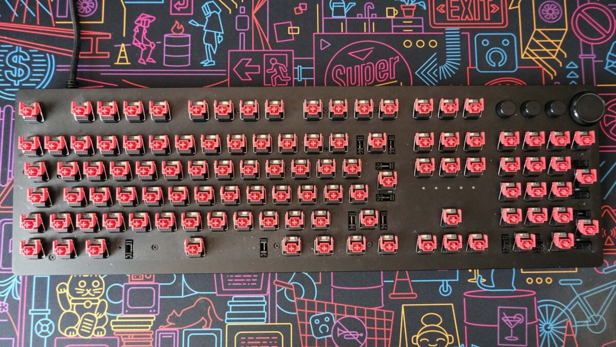 A top-down view of a Razer Huntsman V2 keyboard, keycaps removed, prior to cleaning.