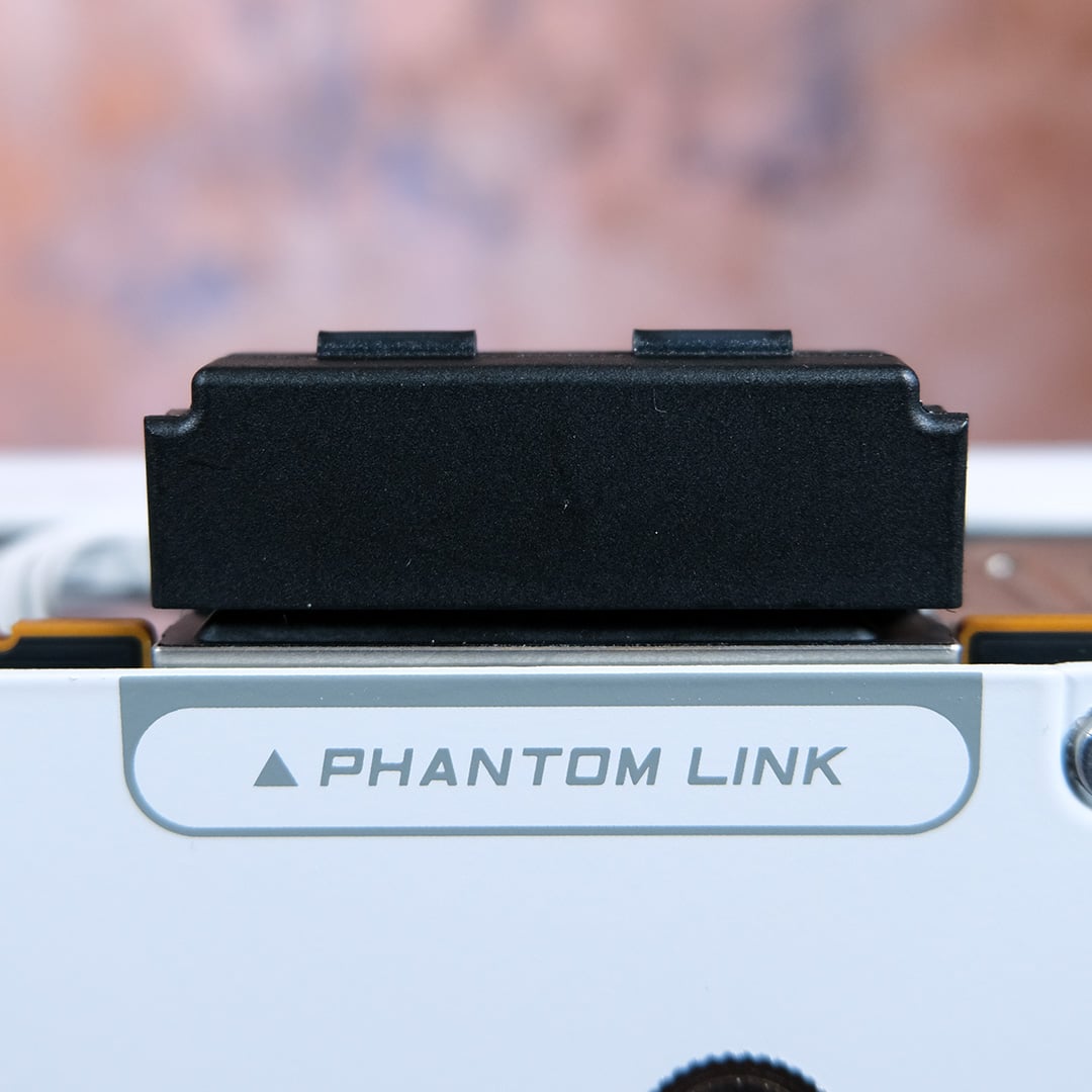 A close-up of the Phantom Link connector on the Nitro+ Radeon RX 9070 XT PhantomLink Edition, cover installed.