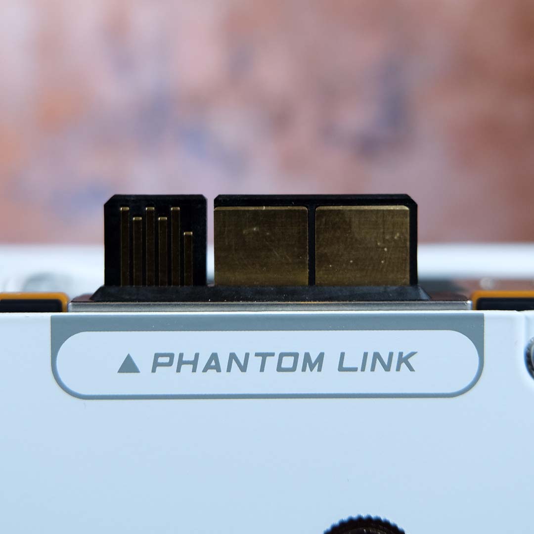 A close-up of the Phantom Link connector on the Nitro+ Radeon RX 9070 XT PhantomLink Edition, cover uninstalled.