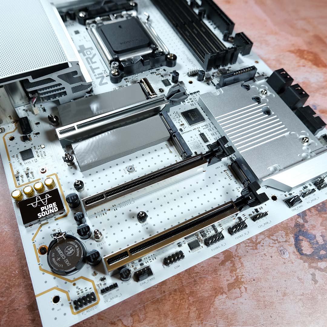 A top-down view of the Sapphire Nitro+ X870EA PhantomLink Polar Edition, M.2 heatsinks removed.