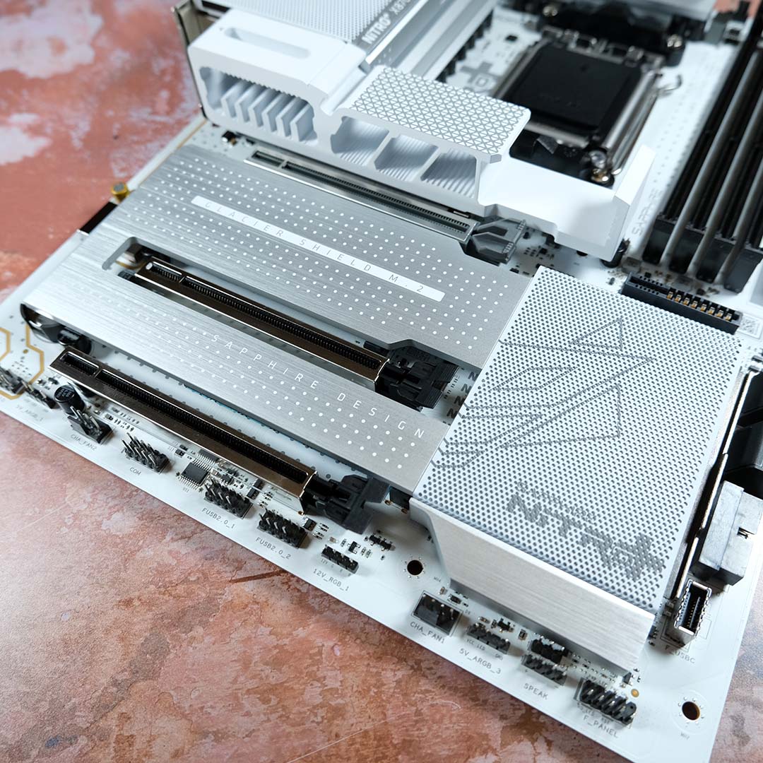 A top-down view of the Sapphire Nitro+ X870EA PhantomLink Polar Edition, M.2 heatsinks installed.