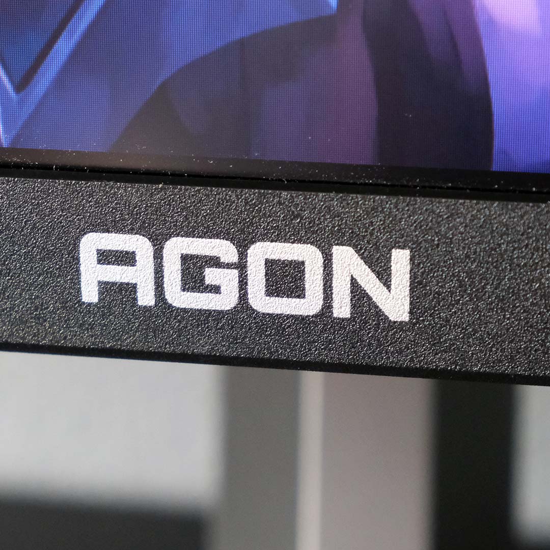 A close-up of the Agon logo printed on the AOC Agon Pro AG276QSG2.