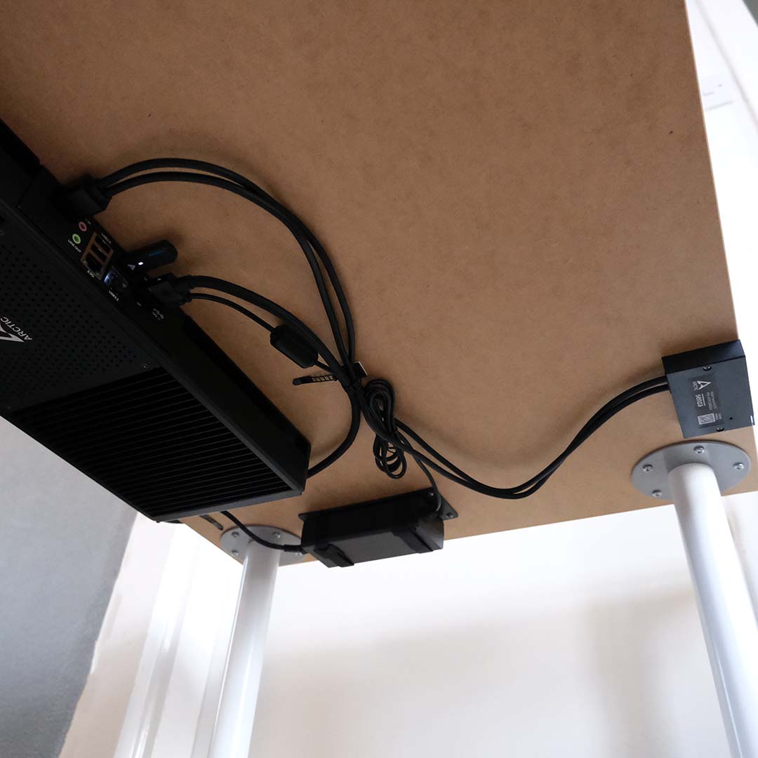 A complete Arctic Senza AI 370 system, powered on, underneath a desk.