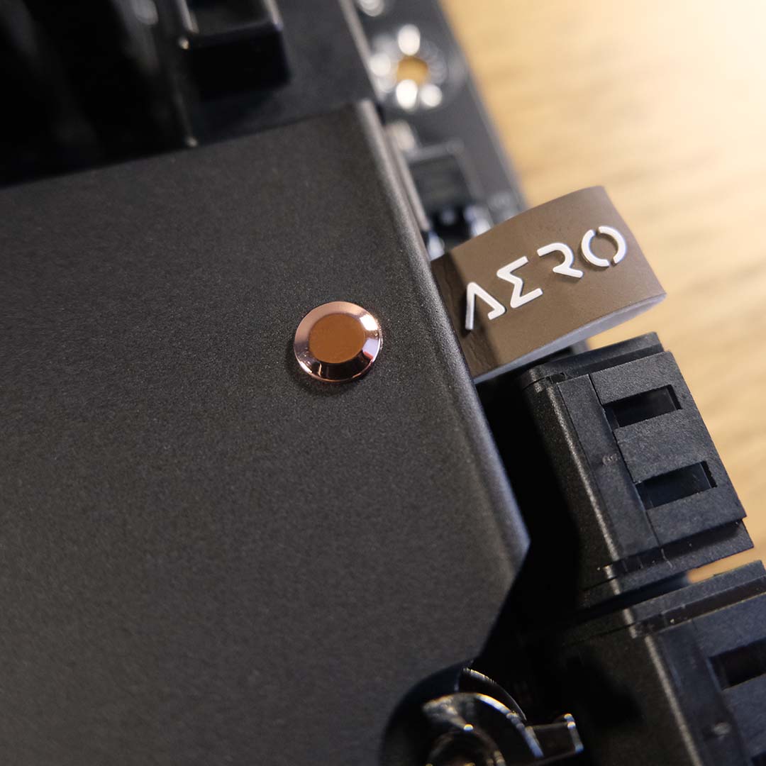 A close-up of the copper truncated cones and leather pull straps on the Gigabyte X870E X3D Dark Wood's heatsink.