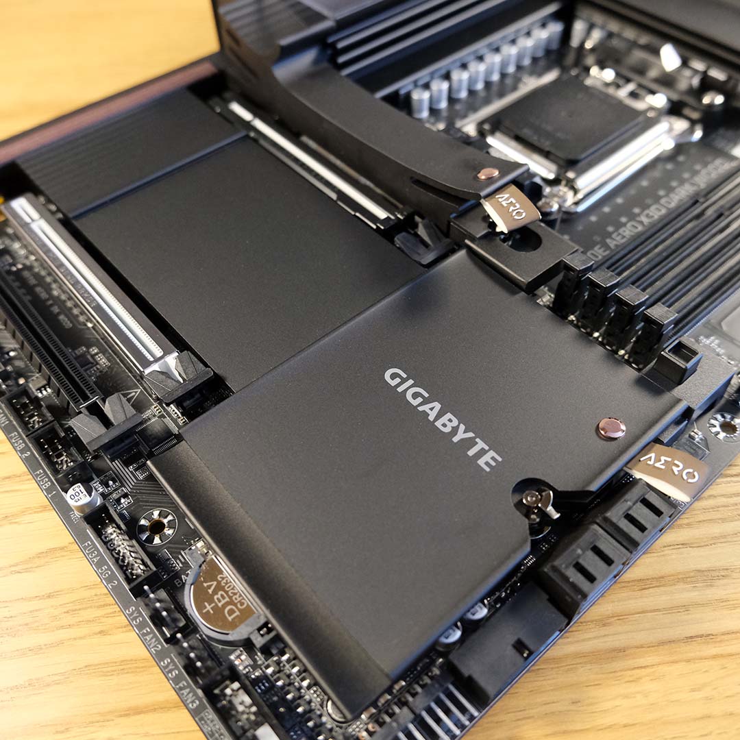 A large metal heatsink covers the Gigabyte X870E X3D Dark Wood's expansion slots.