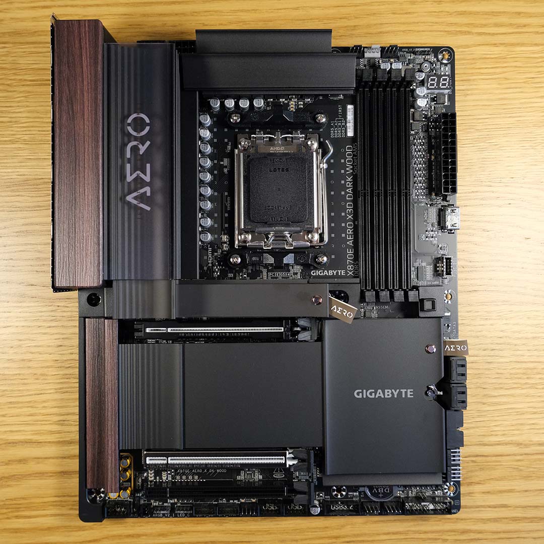 A top-down view of a Gigabyte X870E X3D Dark Wood motherboard.