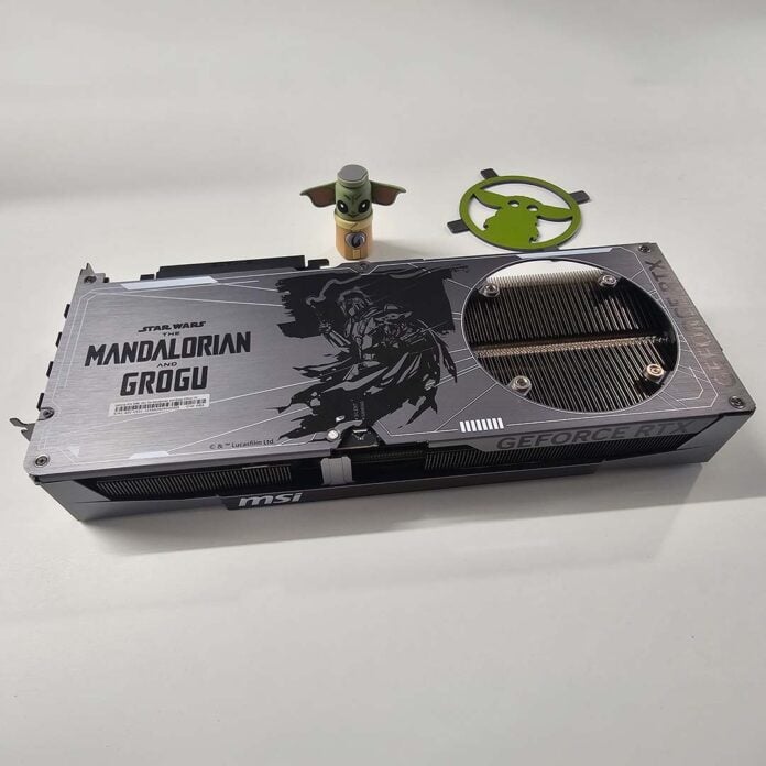 A group shot of the MSI GeForce RTX 5080 16GB The Mandolorian and Grogu Edition OC (front), VGA stand (rear centre), and backplate (rear right).