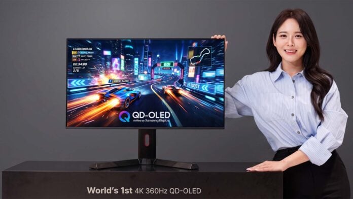 A person (right) standing next to the world-first 4K/360Hz monitor (left) made by Samsung.