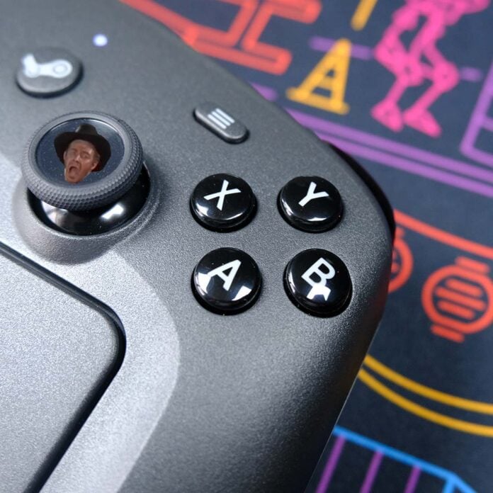 A close-up of a Steam Controller, with the face of Private Wilhelm on its thumbstick.