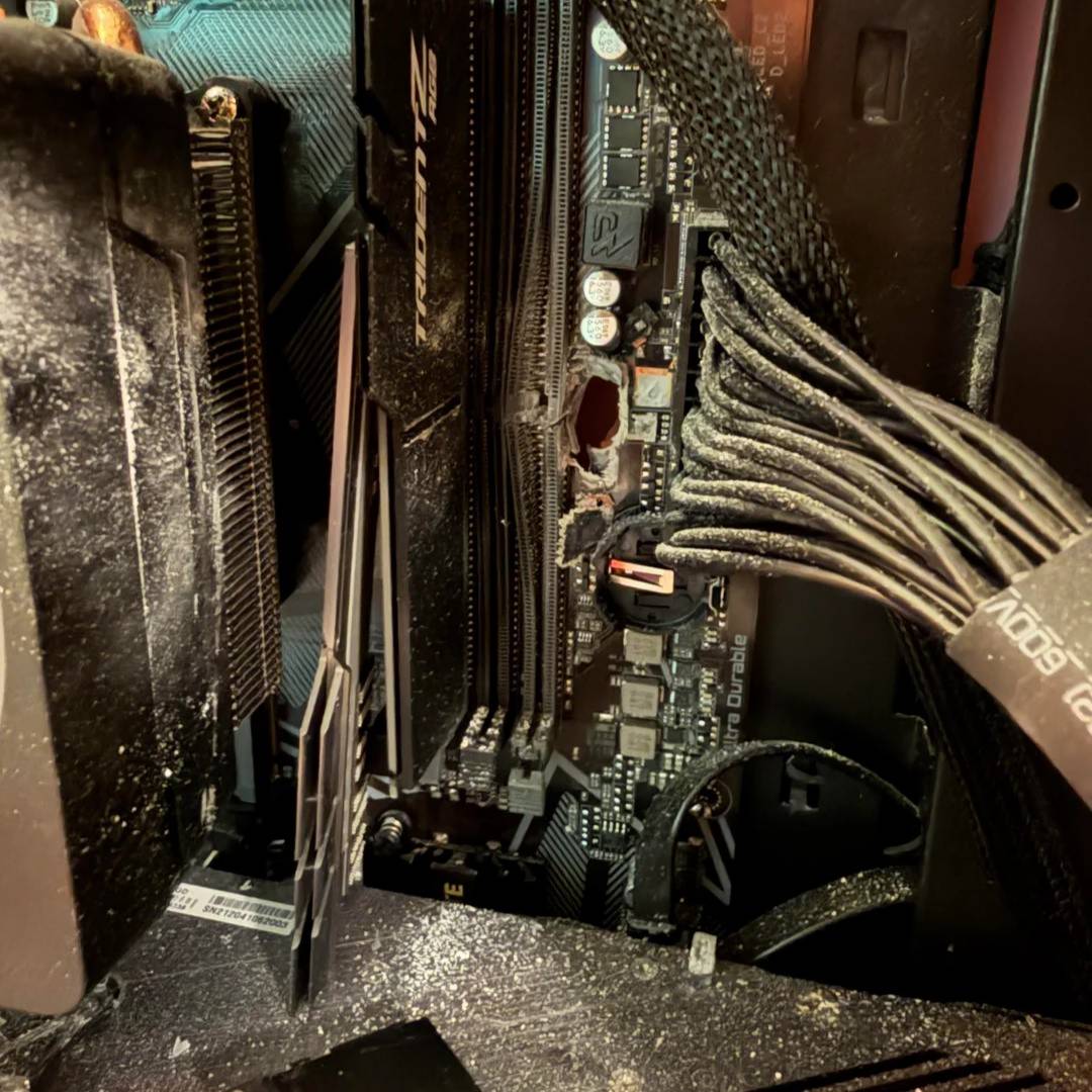 Gaming PC motherboard with G.Skill memory after a bullet hit.