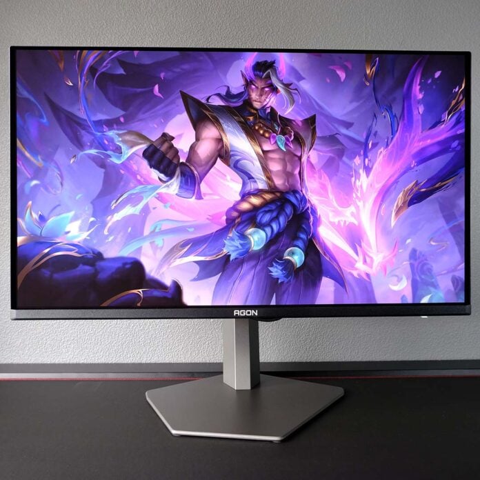 An AOC Agon Pro AG326UZD2 monitor, displaying League of Legends champion artwork.
