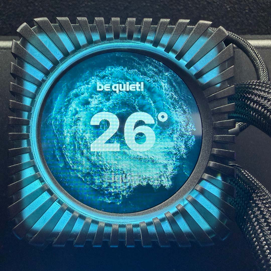 A close-up of the be quiet! Light Loop IO LCD's pump unit, in black, showcasing its IPS LCD display, with blue LEDs.