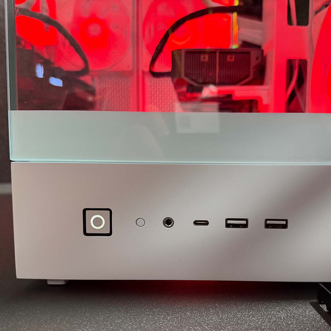 A close-up of the power and reset buttons, alongside 3.5mm input and USB ports, on the be quiet! Pure Base 803 LX, mounted to the front panel.