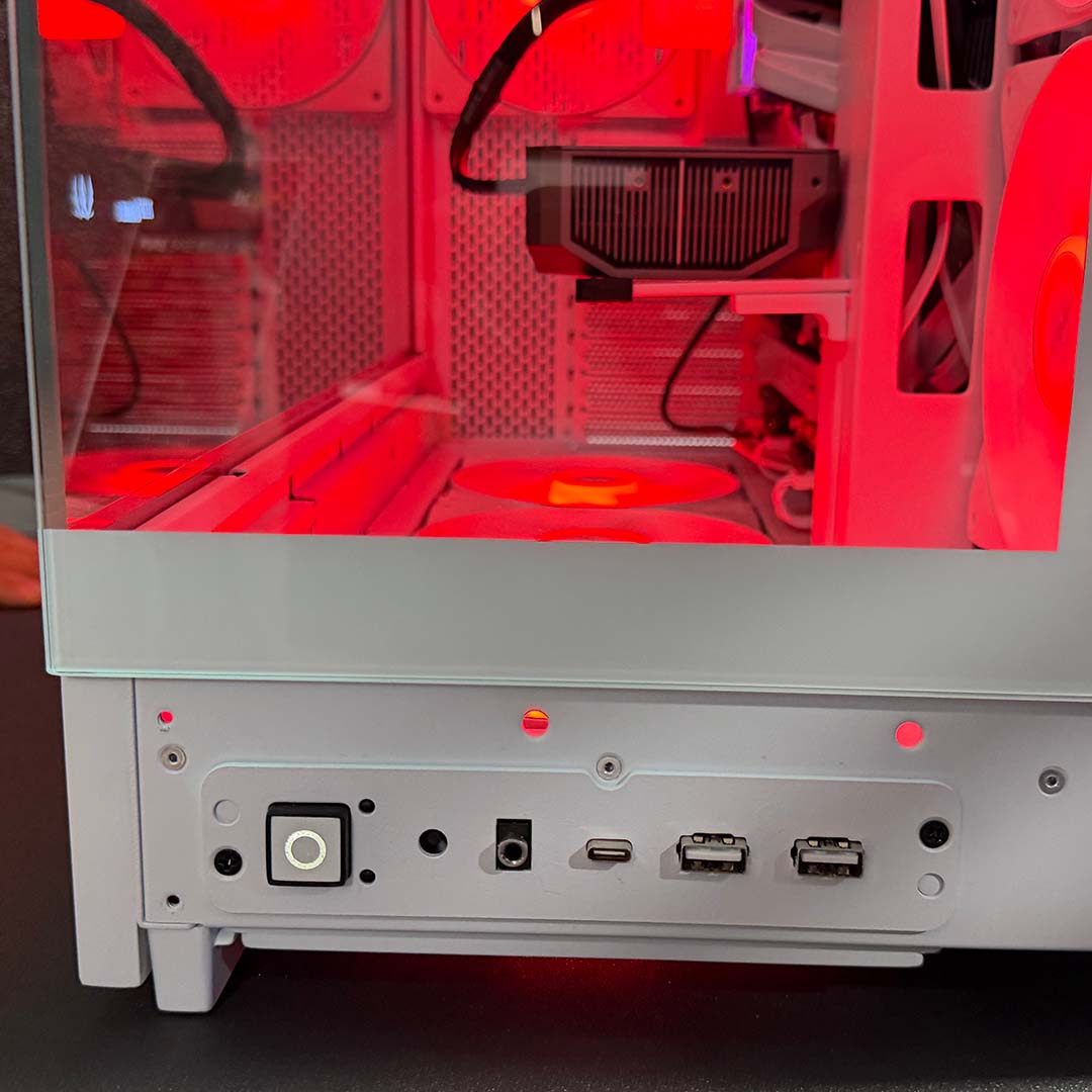 A close-up of the power and reset buttons, alongside 3.5mm input and USB ports, on the be quiet! Pure Base 803 LX, mounted to the front panel.