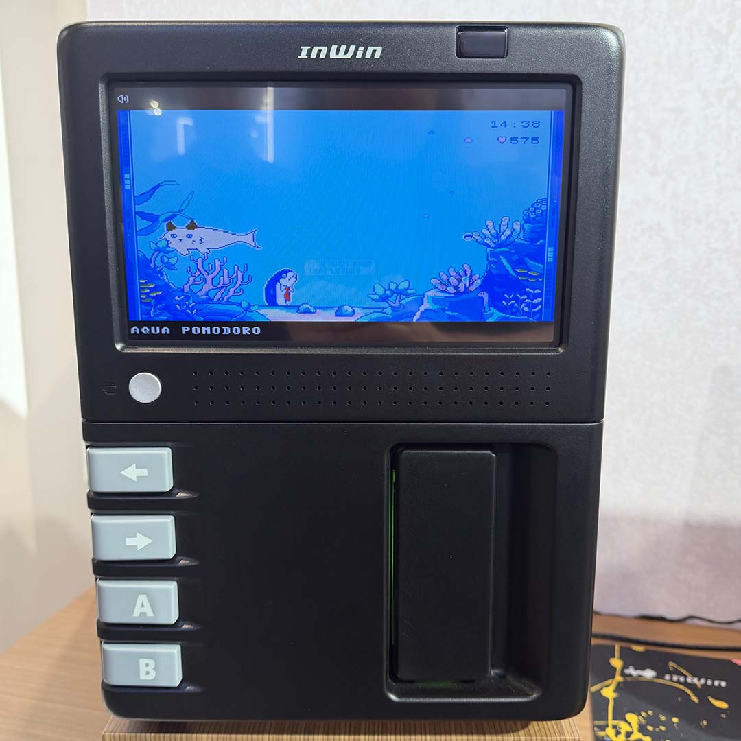 The front of the InWin GX-285 PC case, running one its arcade-style games on its LCD panel.