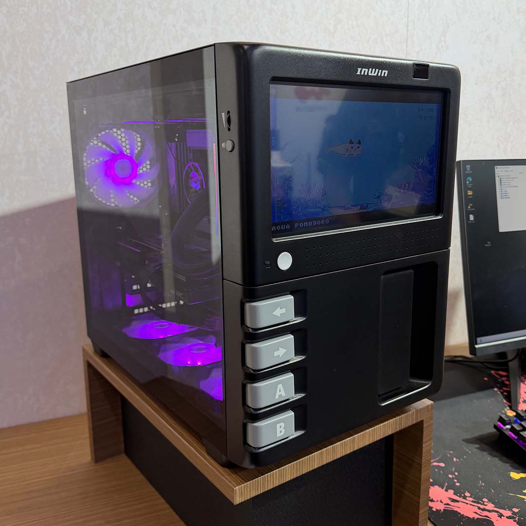 A side-on view of the InWin GX 285, showcasing its LCD front panel and tempered glass side panel.