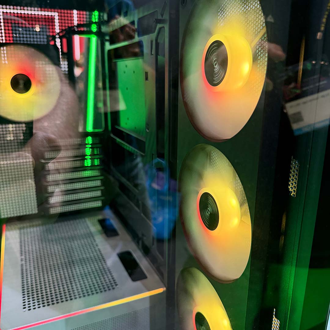 A close-up of the triple fan intake and rear exhaust inside the Montech TG3 PC case.