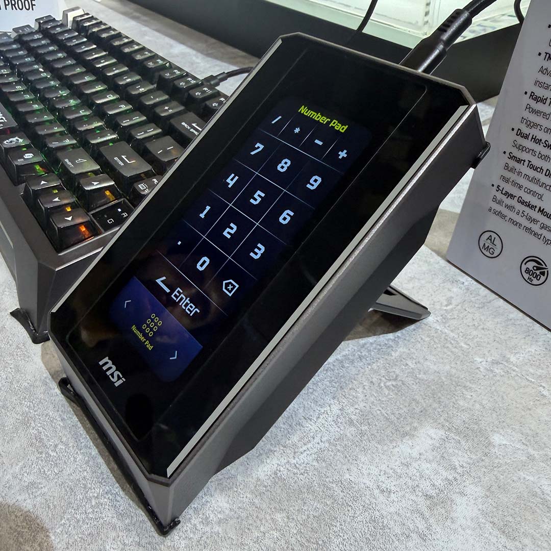 The MSI Strike Nexus, raised up by its hinge, displaying a number pad.