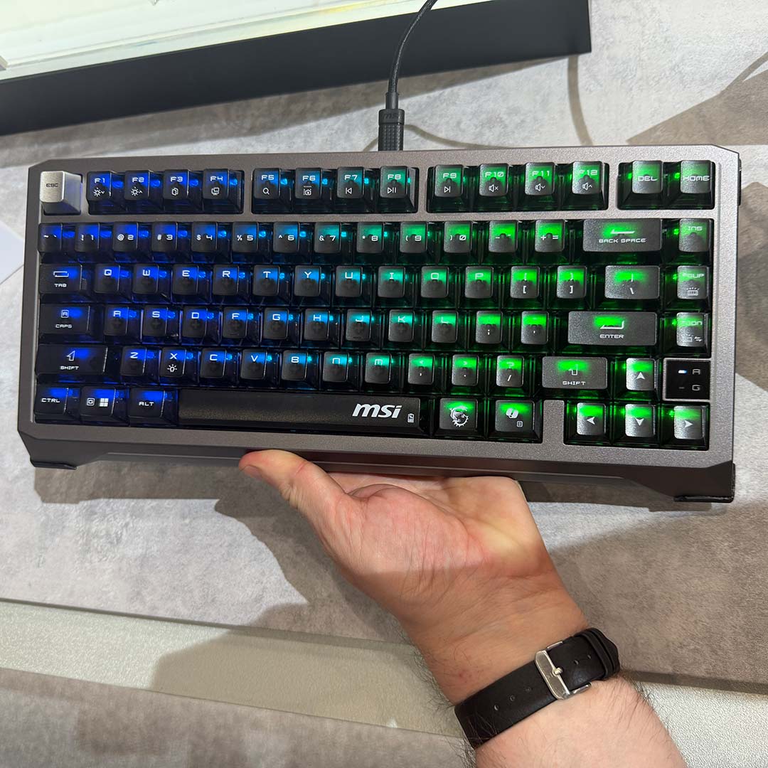 The Strike Alloy TMR keyboard, held by a hand.