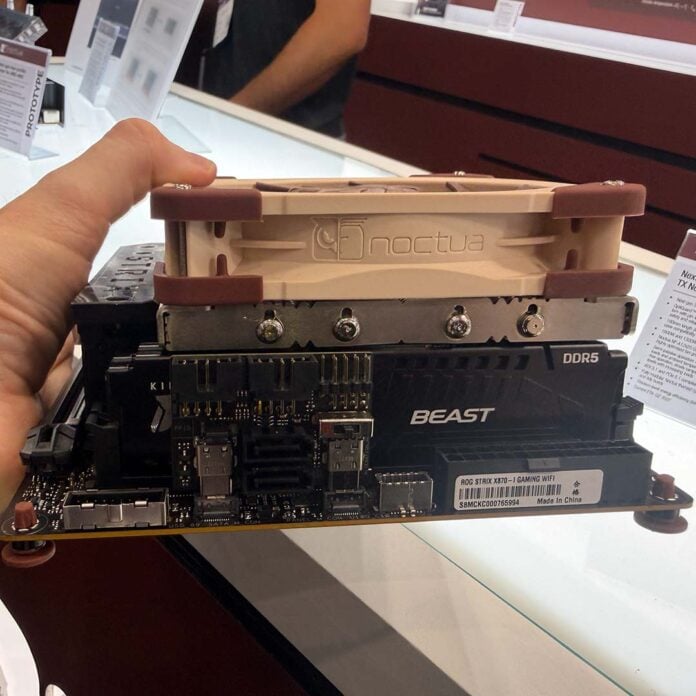 A side-on view of Noctua's prototype low-profile AM5 CPU cooler, installed on a motherboard.