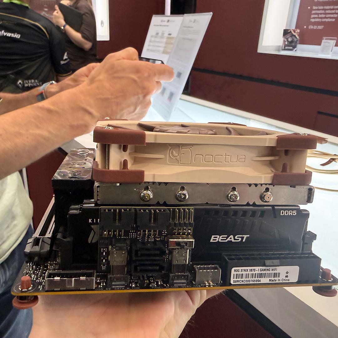 A side-on view of Noctua's prototype low-profile AM5 CPU cooler, installed on a motherboard.
