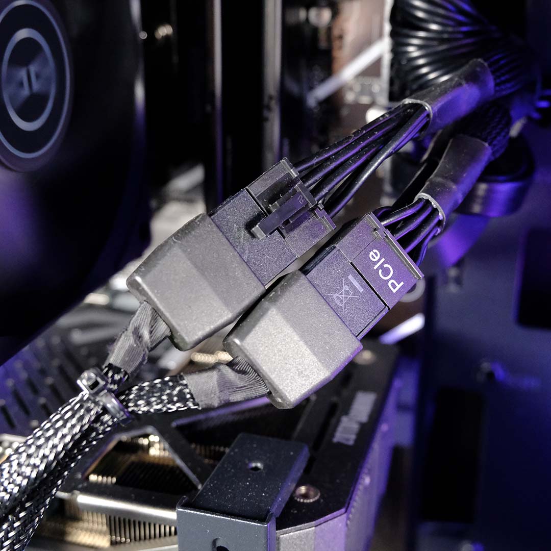 A close-up of PCIe 8-pin connectors and adapter inside the PCSpecialist Storm Elite II.