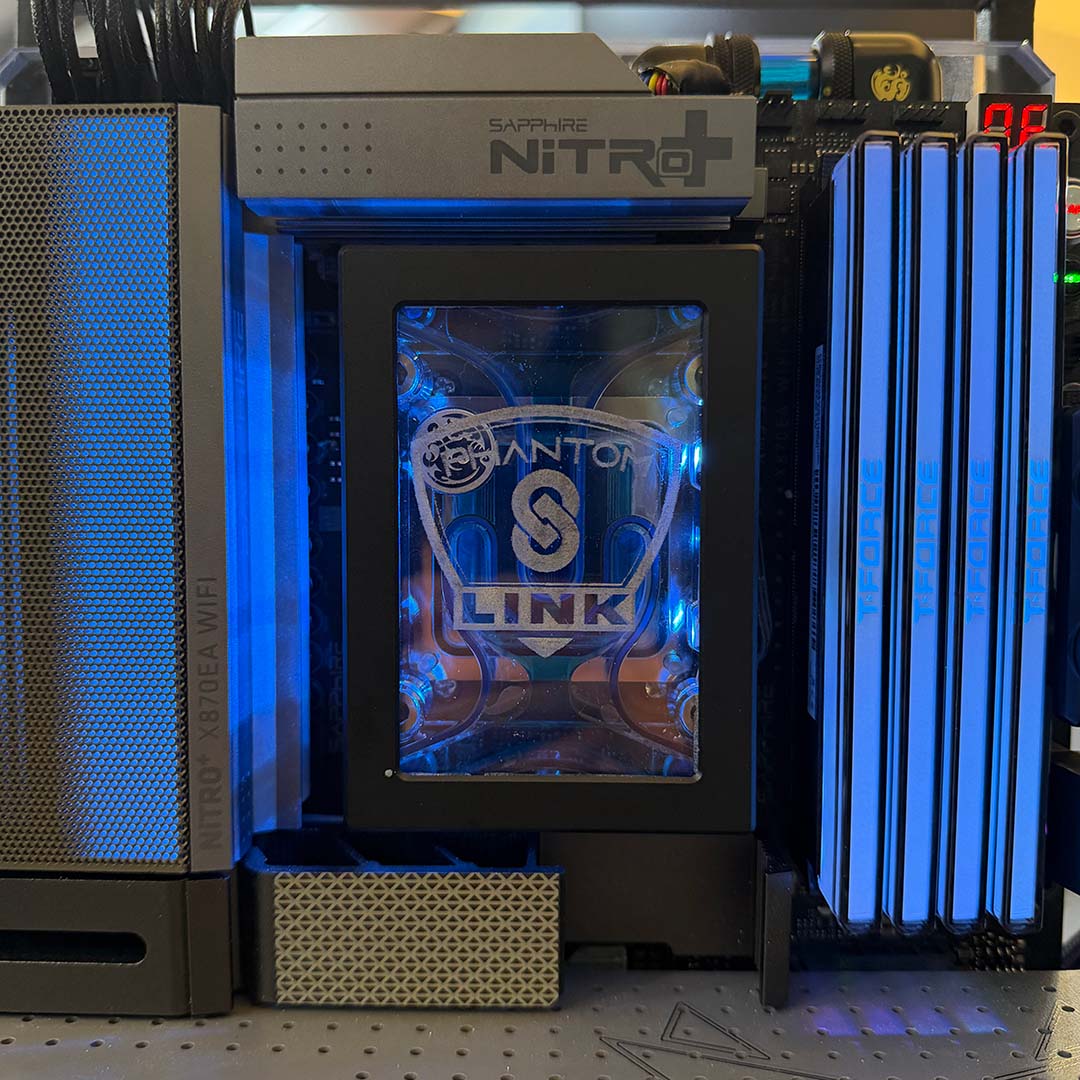 A close-up of Sapphire Nitro+ X870EA PhantomLink Edition, complete with blue T-Force RAM (right) and unique cooling (centre).