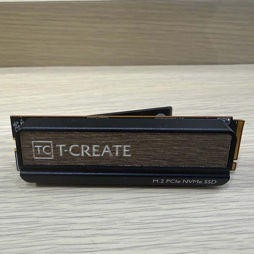 A TeamGroup T-Create SSD, featuring a wood effect finish on its heatsink.