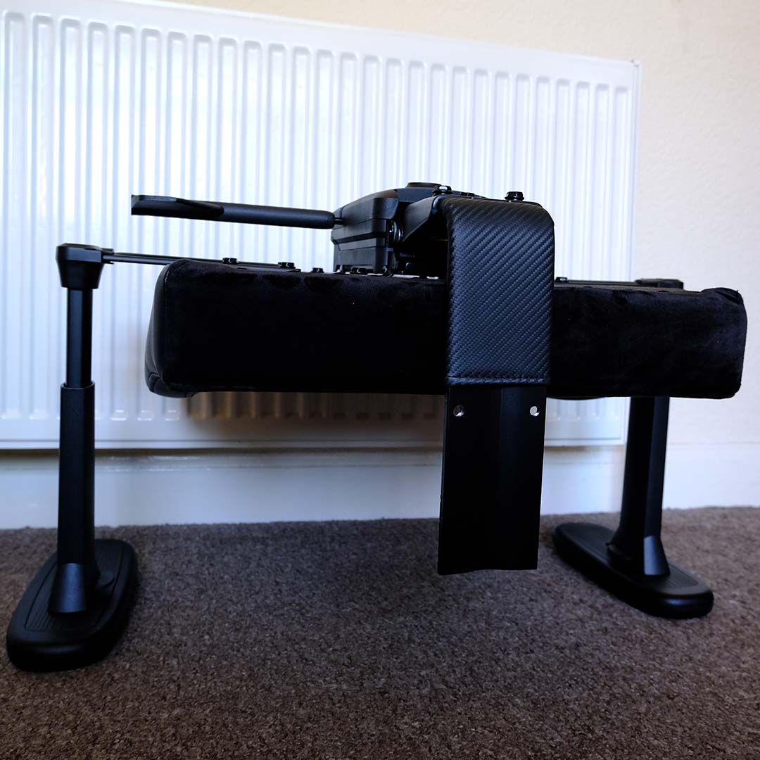 The ThunderX3 Solo 360 gaming chair, mid-construction and upside down, with arms, seat, and spine.