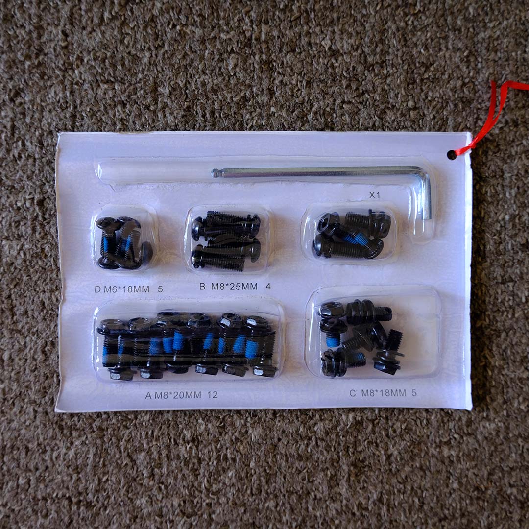 A top-down view of the screws and allen key that arrive with the ThunderX3 Solo 360 gaming chair.
