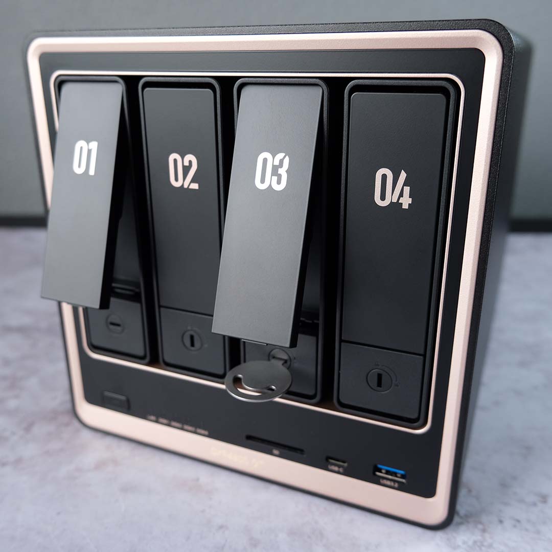 The front of the Ugreen NASync DXP4800 GT, with two bays unlocked and unhooked.