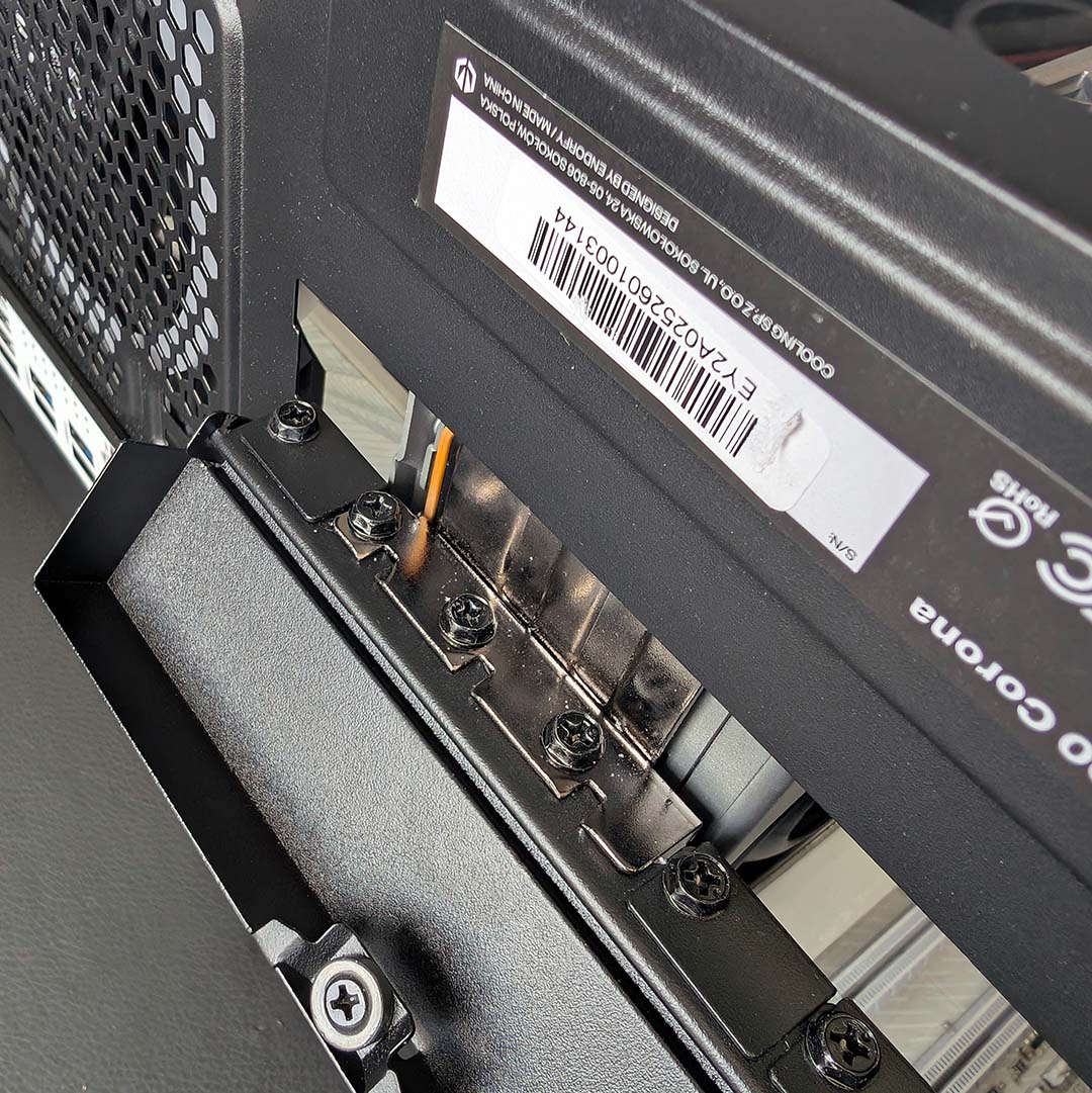 A close-up of screws securing a graphics card in the Fishtank 6000 Corona.