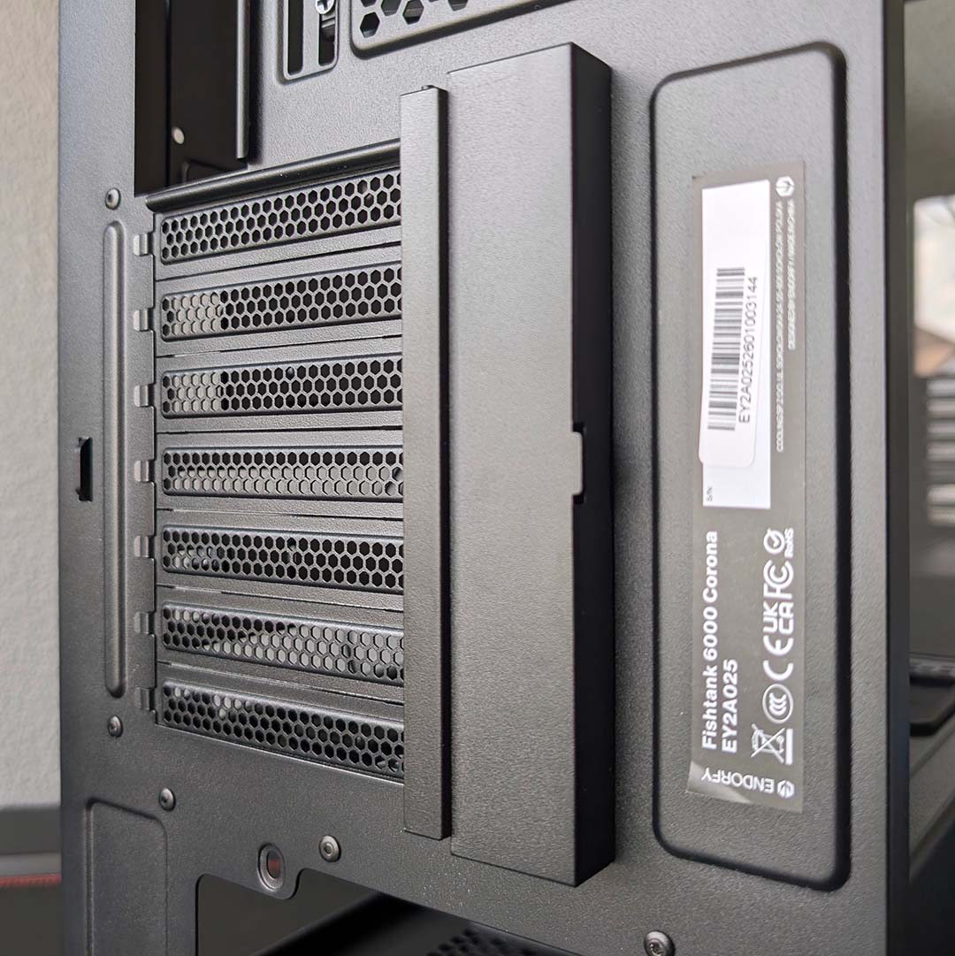 A close-up of the shroud that hides the Fishtank 6000 Corona's screws for add-in cards.