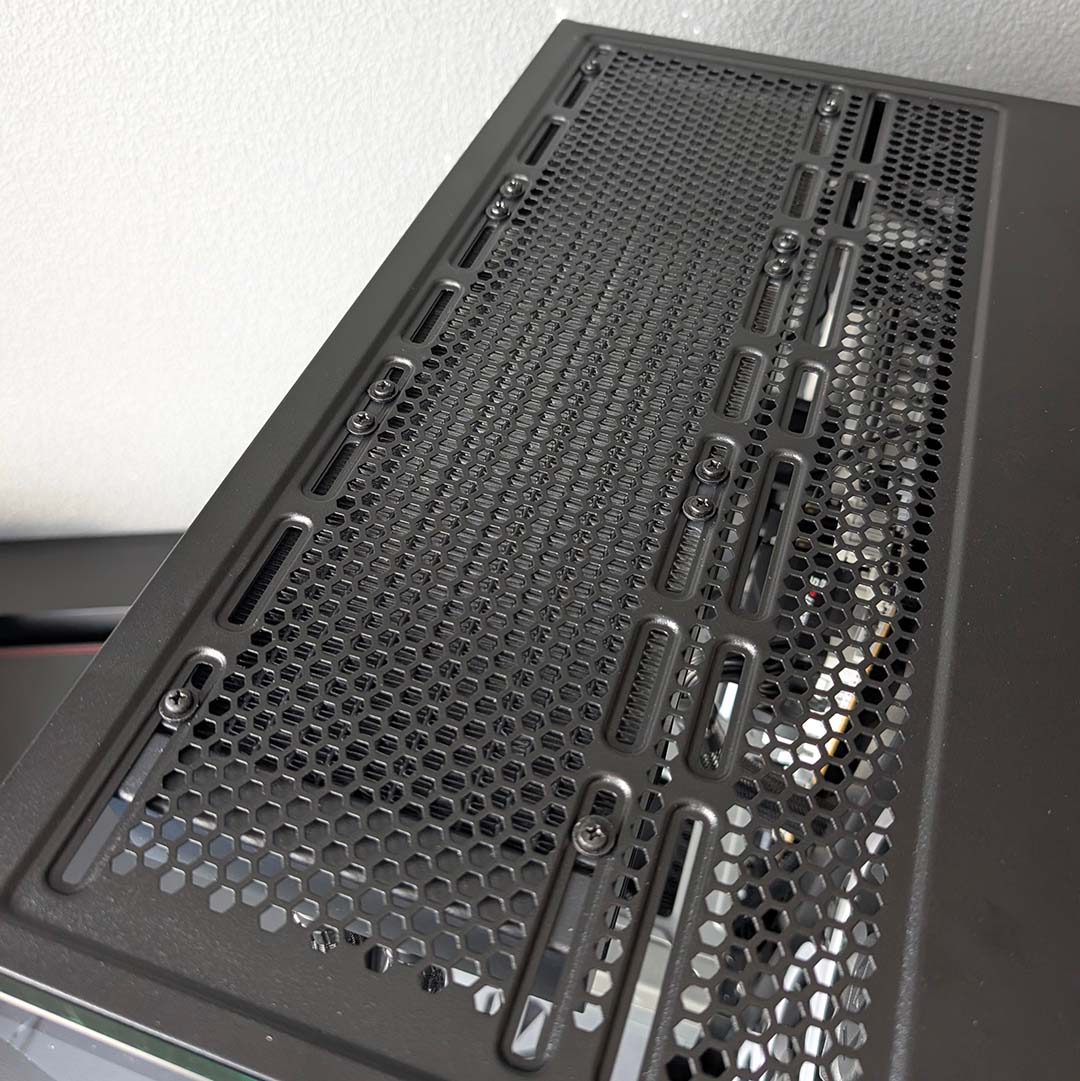 Screws marry an AIO water cooler with the Fishtank 6000 Corona's top panel.