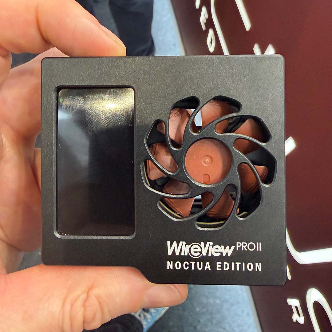 A Thermal Grizzly Wire View Pro II Noctua Edition held between a finger and thumb.